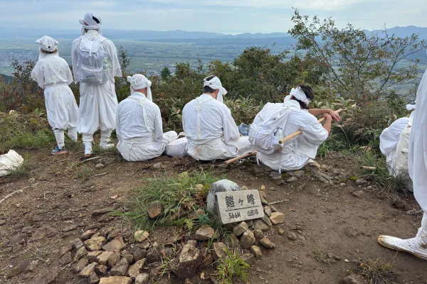 Solitary figure in Yamabushi garments staring into the distance atop Mt. Kinbo